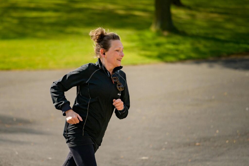 An individual running in a park during daylight